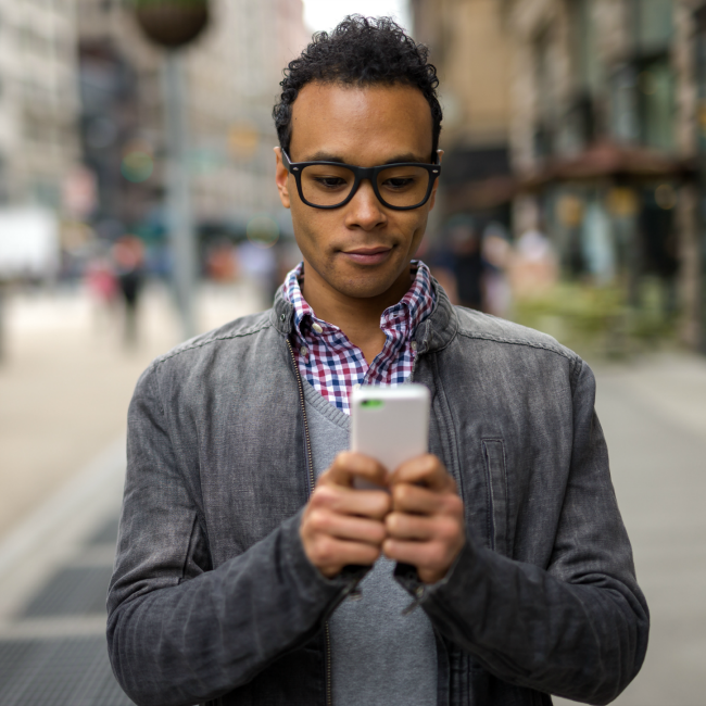 man walking down street on phone