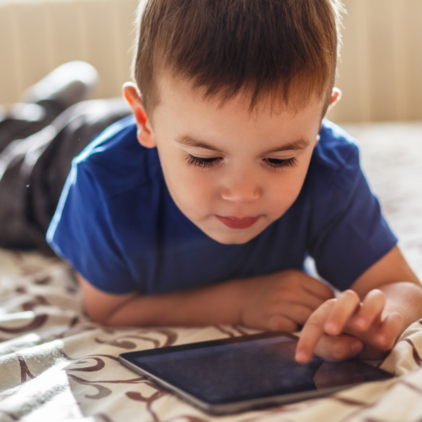 young boy looking at tablet