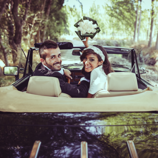 newly wed couple in convertible
