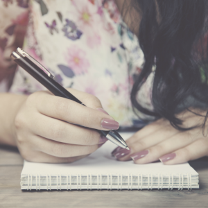 woman writing in journal