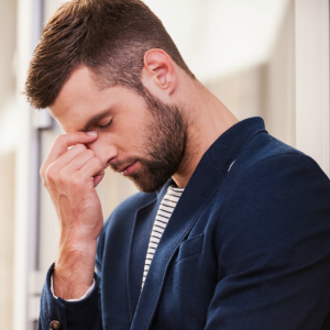 man with hands on face