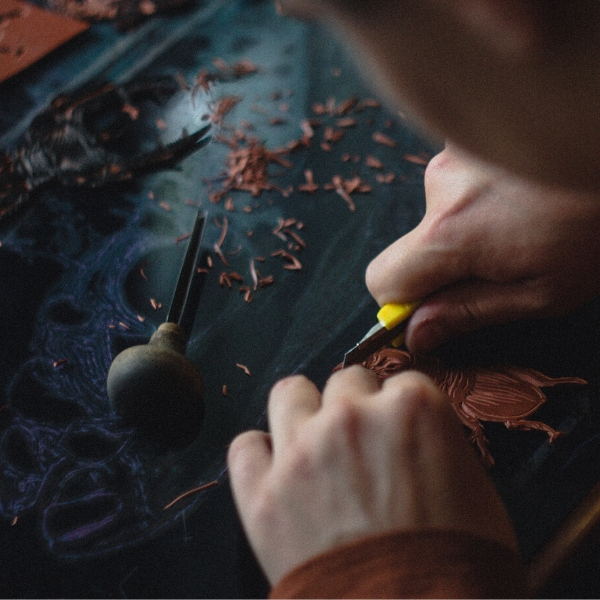 hands carving wood