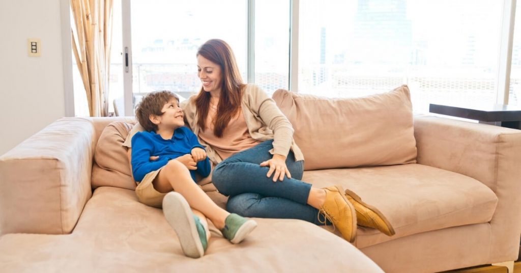 mom talking to son on couch