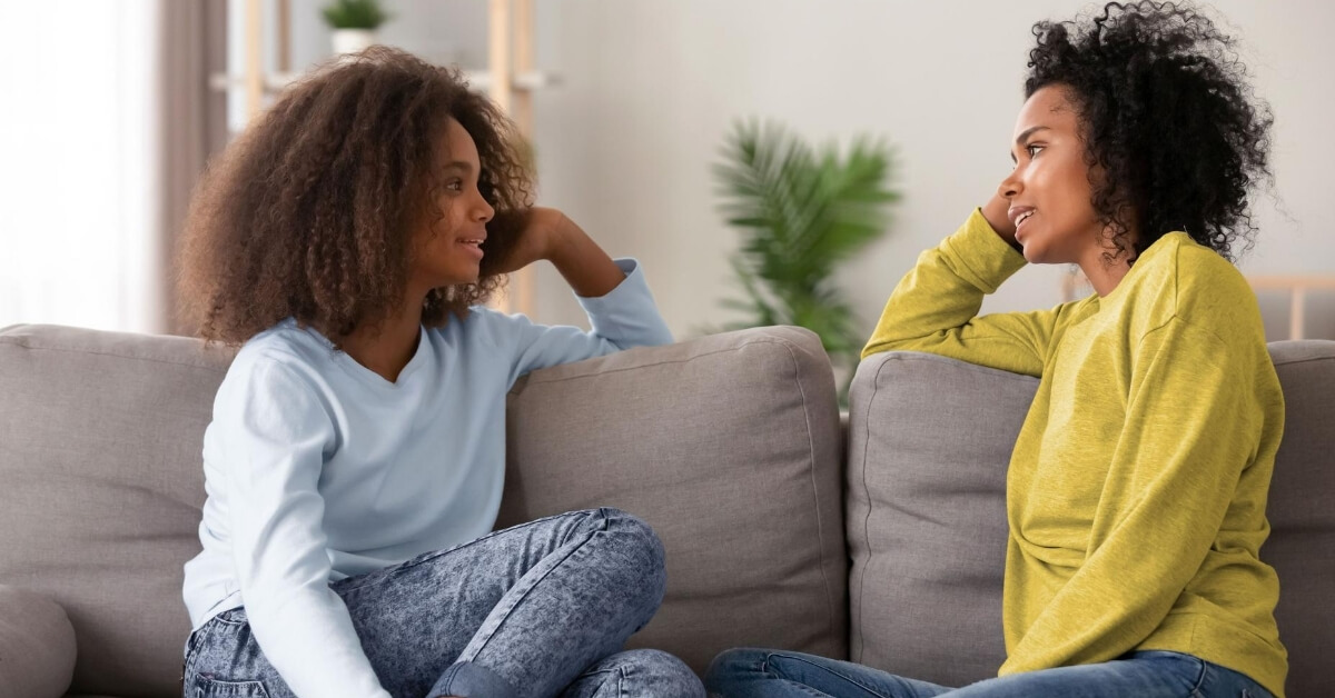 mom talking with daughter on couch