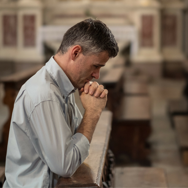 man praying at church