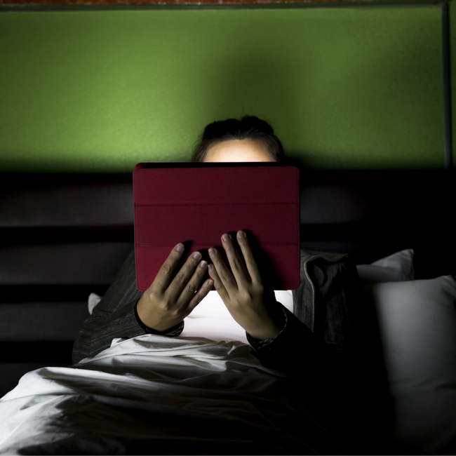 girl watching tablet at night