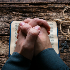 praying hands with cross