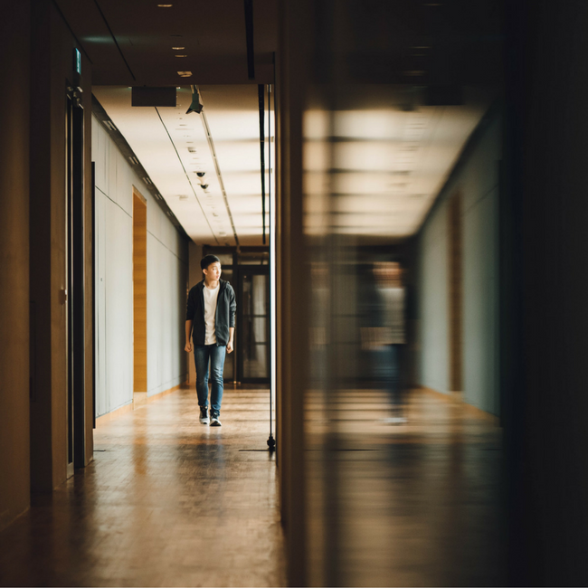 high school boy walking through hallway