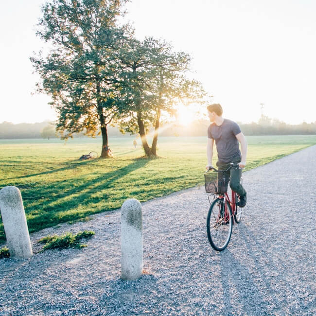 man biking on path alone