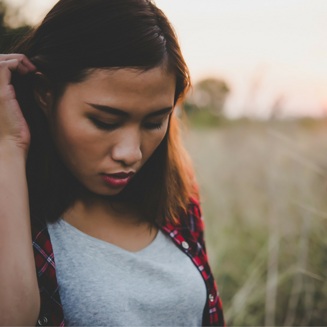 teenage girl looking down ashamed