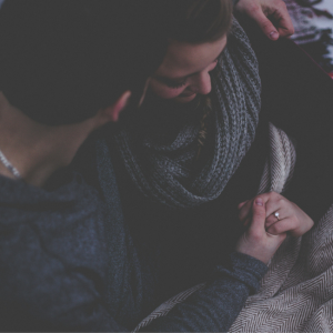 engaged couple holding hands