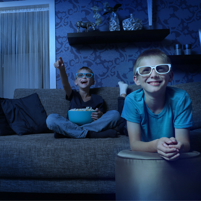 two boys watching movie at home