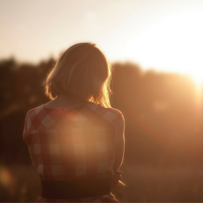 woman looking into field