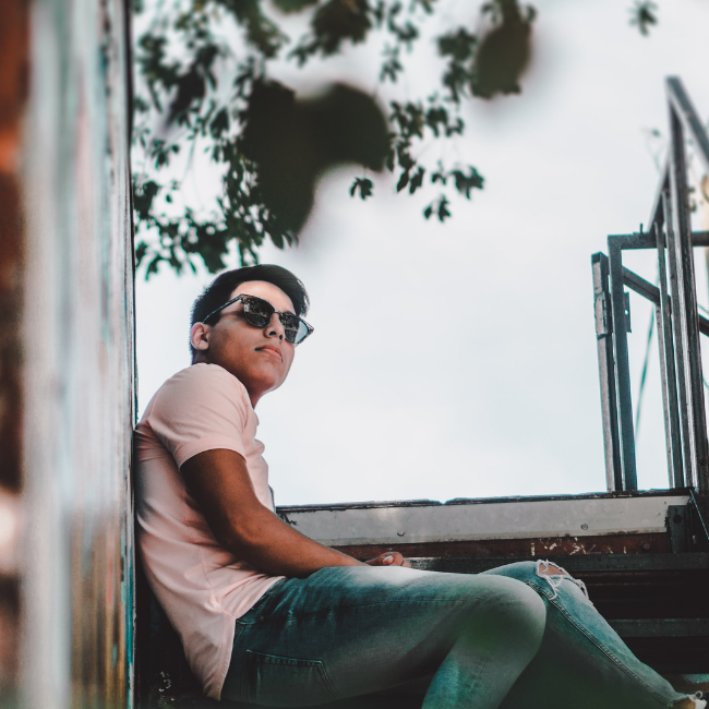 teenage boy sitting on outdoor stairs