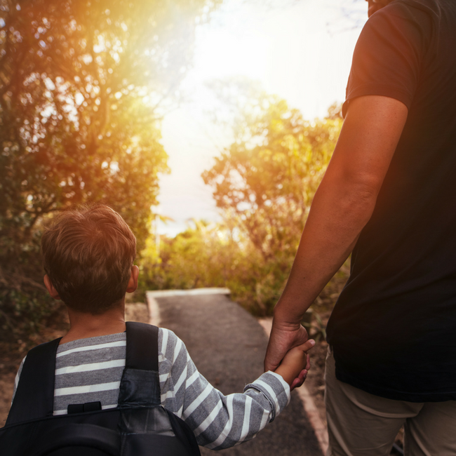 dad holding young son's hand