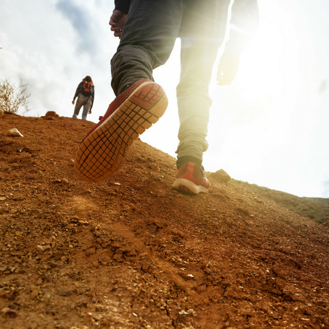 man climbing uphill