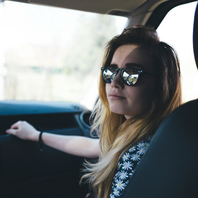 teenage girl looking back in car