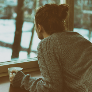 woman looking out window