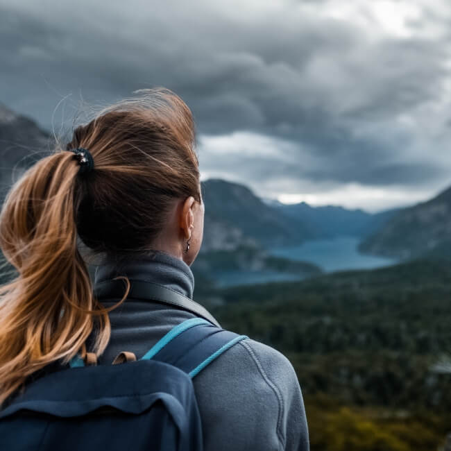 woman overlooking mountain river