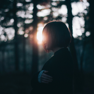 woman standing in woods