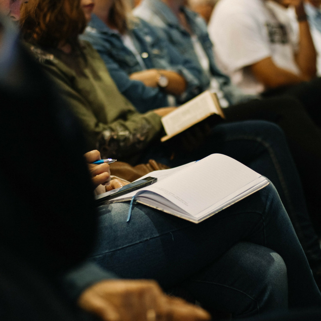 church members taking notes during sermon