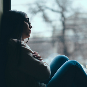 teenage girl sitting in window