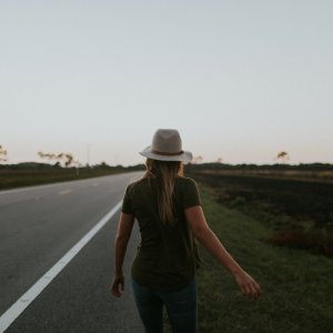 woman walking down empty road