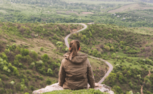 woman sitting on mountain