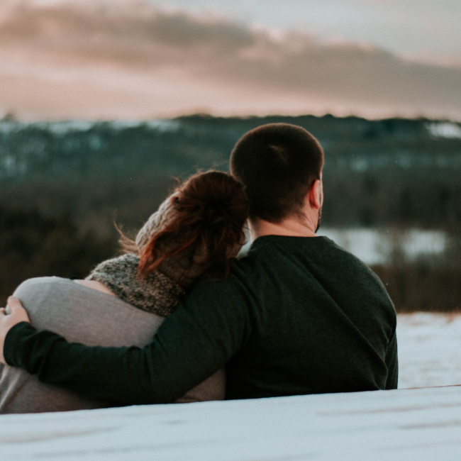 man comforting woman