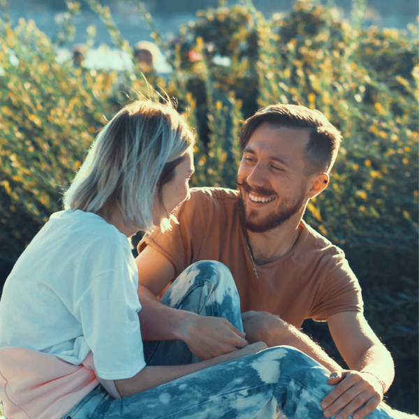 couple talking on blanket outside