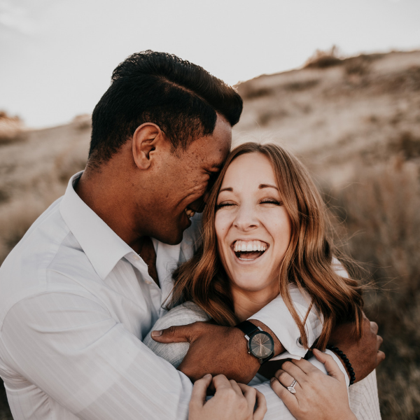 happy couple hugging outside