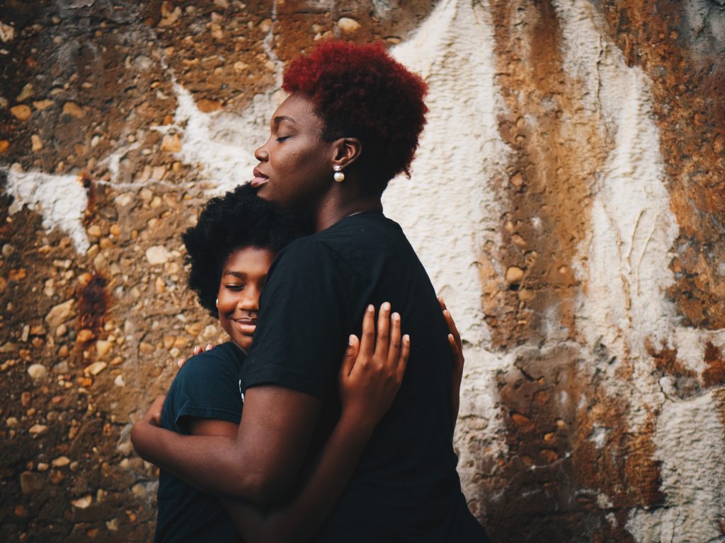 mom hugging daughter