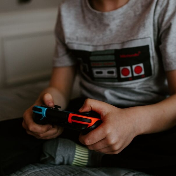 young boy on video game controller