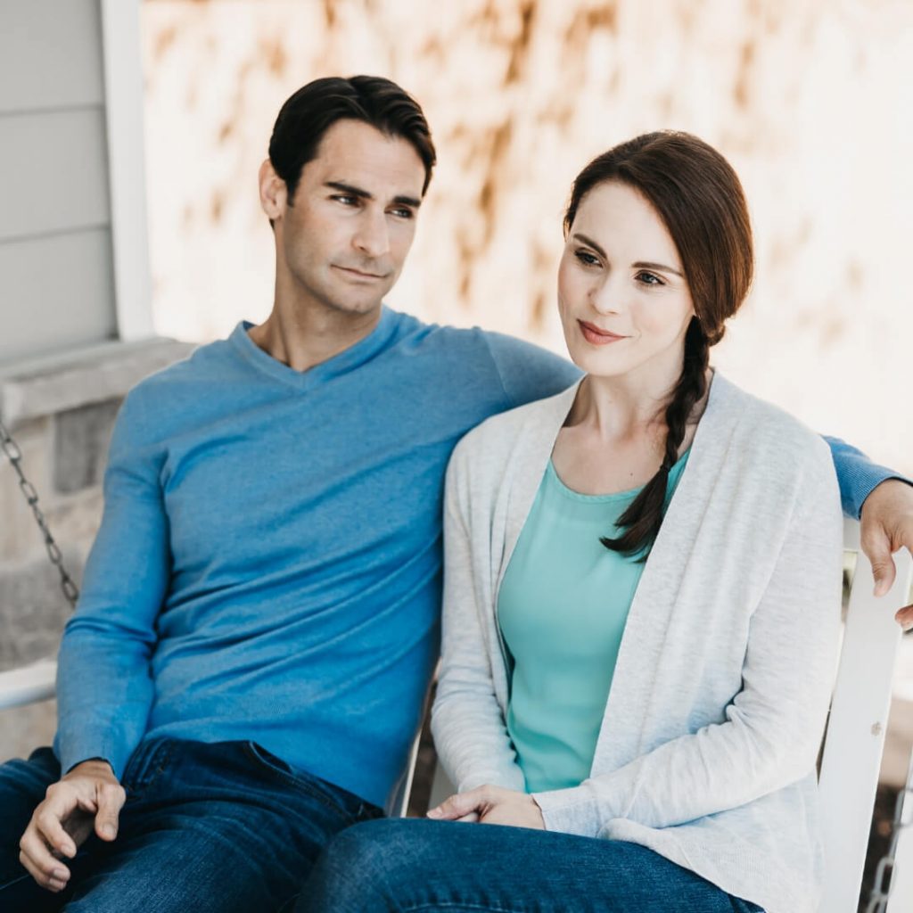 couple sitting together on porch swing