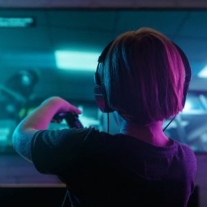 young boy playing video game with headphones on