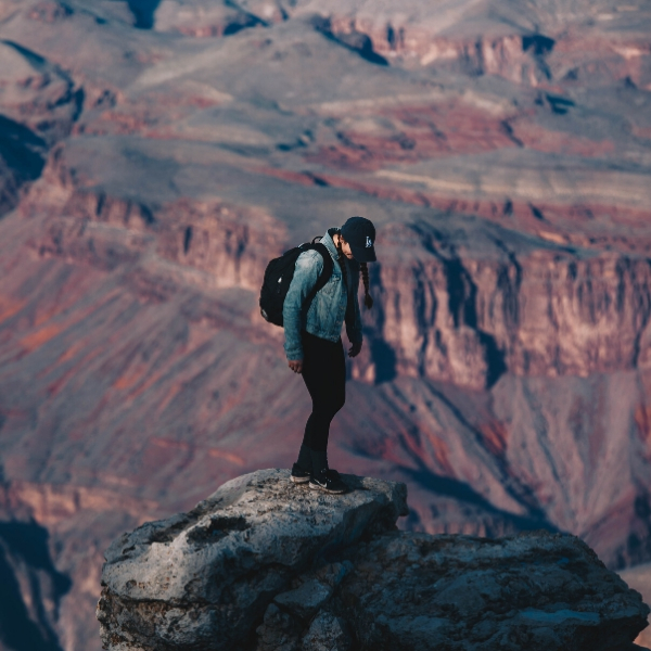 man standing on top of mountain