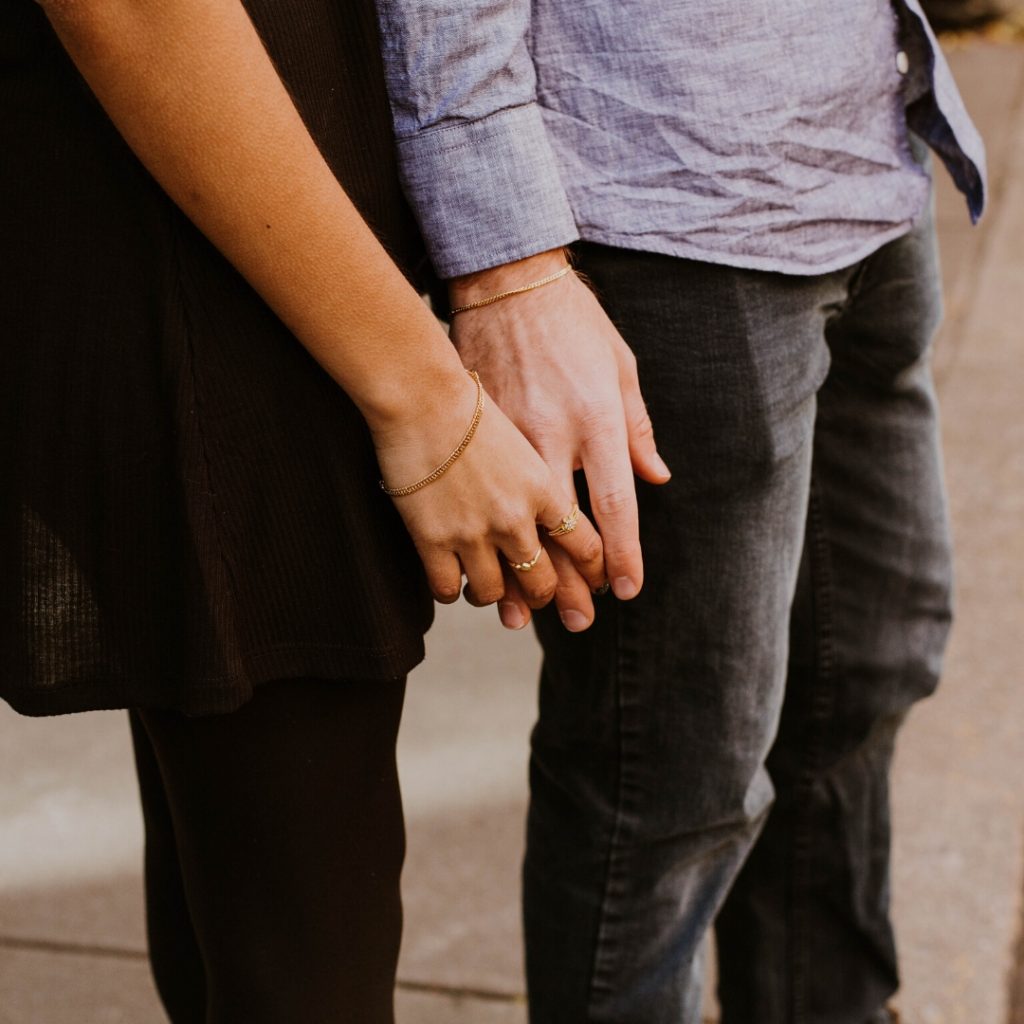 couple with hands touching