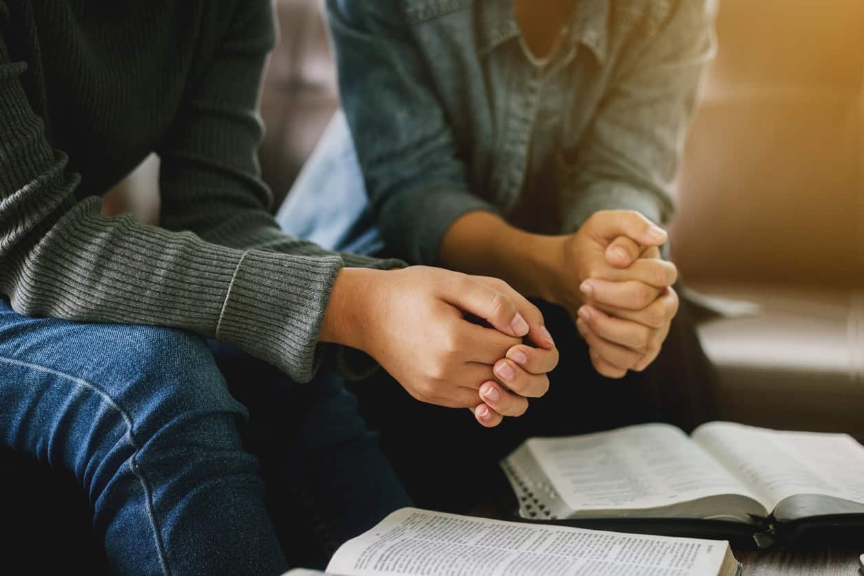 Two women studying the Bible.