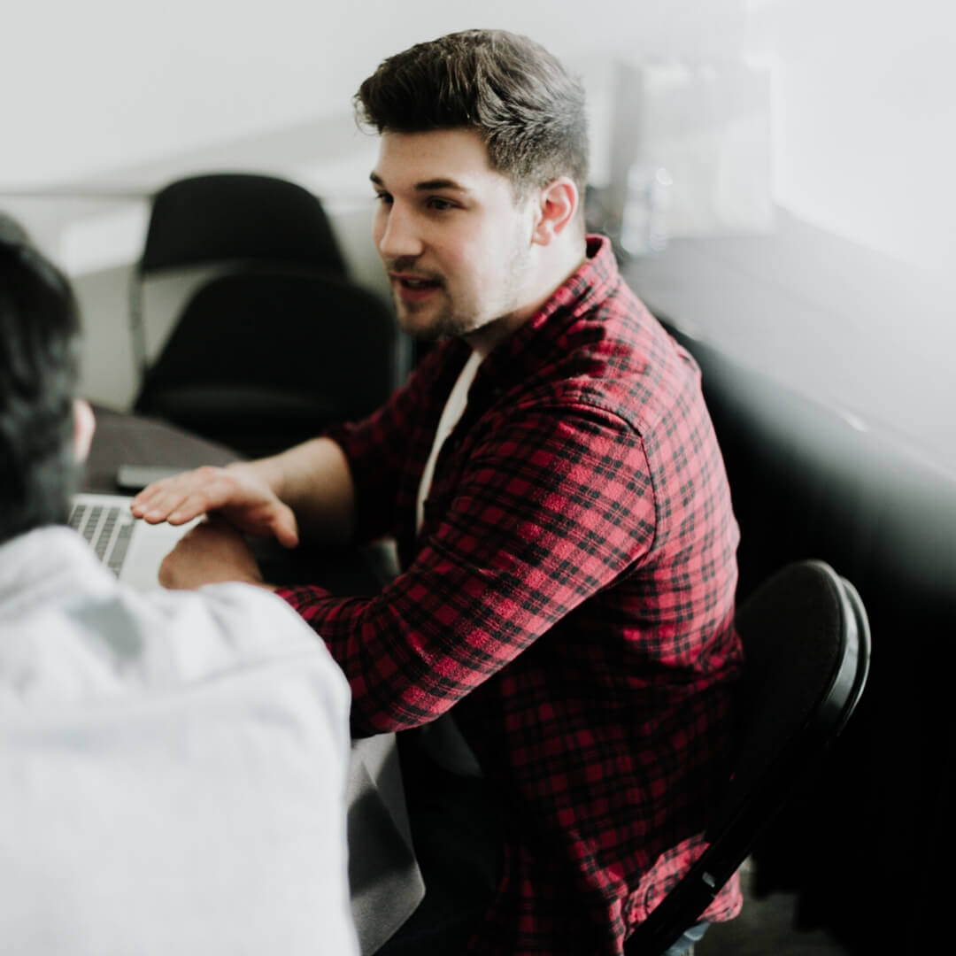 man talking with group at table