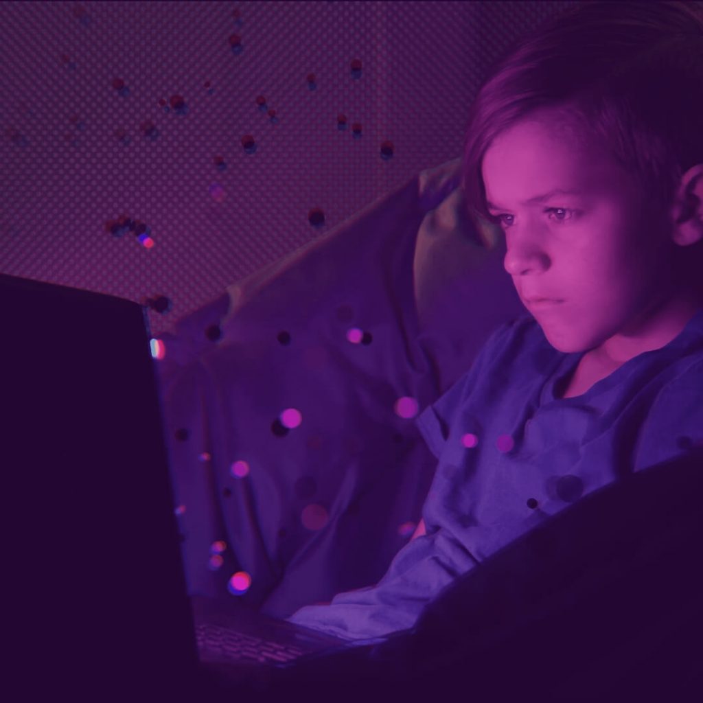 young boy looking at computer alone