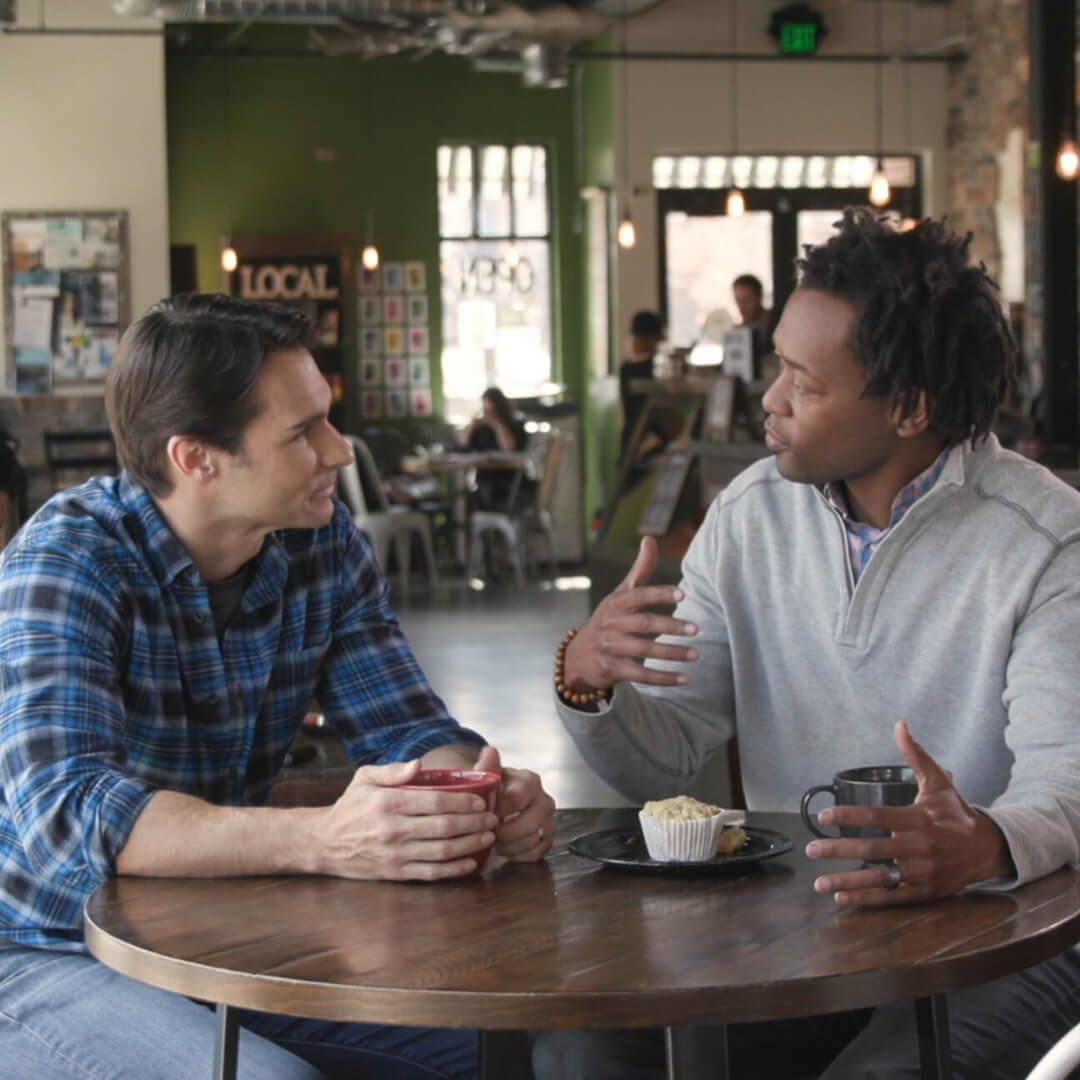 two men talking at coffee shop