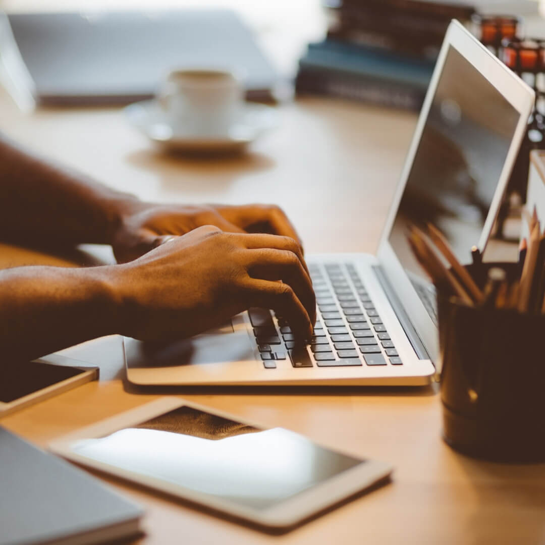 man typing on laptop