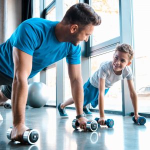 dad and son doing pushups with dumbbells