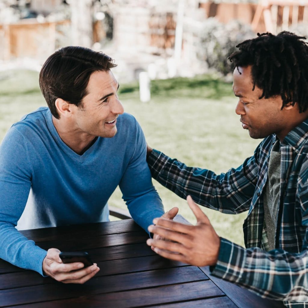 two friends talking outside