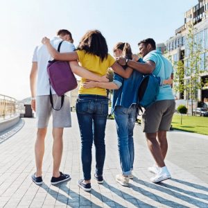 high school students walking down sidewalk together