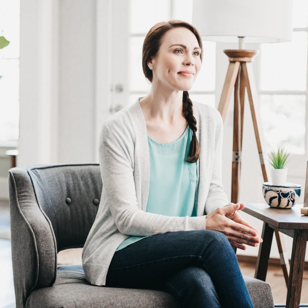 woman sitting in a chair and smiling