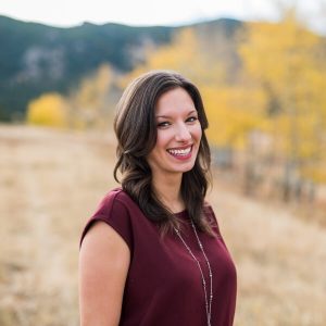 woman smiling outside in fall