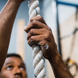 man climbing rope