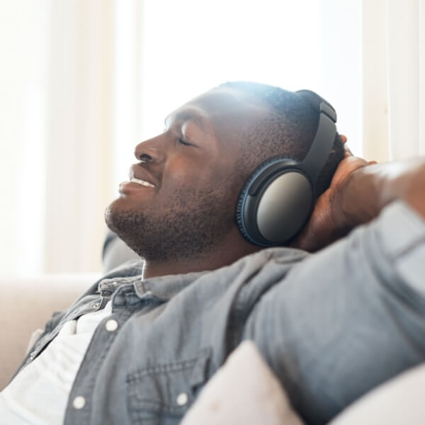 contented man with headphones leaning back