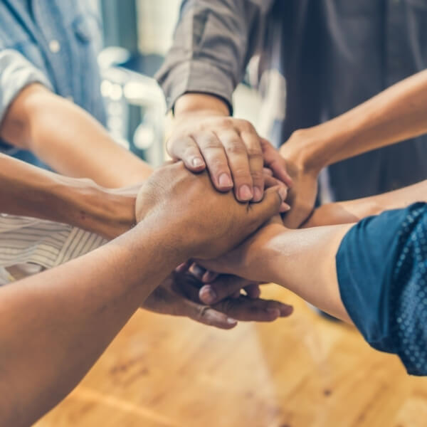 group of people joining hands